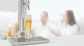Dispensing equipment with glass of hoesl beer.